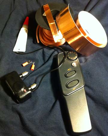 The stuff I purchased to make an electrified bit gag and spurs. A roll of copper tape, a shock collar, a roll of speaker wire, some conductive glue, and assorted wire connectors.