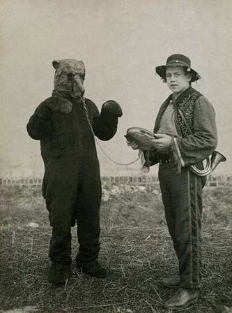 Bear being led by nose ring leash by handler