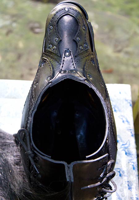 The bottom of the mask illustrating the thickness of the leather and the neck opening.