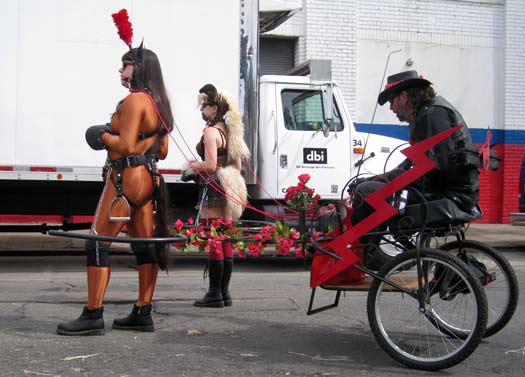 A cart being pulled by two ponygirls at Folsom Street Fair 2012.