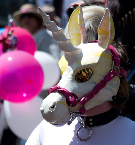 A unicorn preparing to pull a cart for SF Pride Parade